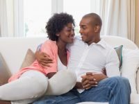 16. Couple-Holding-Hands-on-Couch