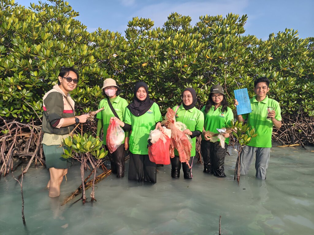Anggota komunitas Sharp Greenerator sedang melakukan aksi bersih-bersih pantai di Pulau Pari.