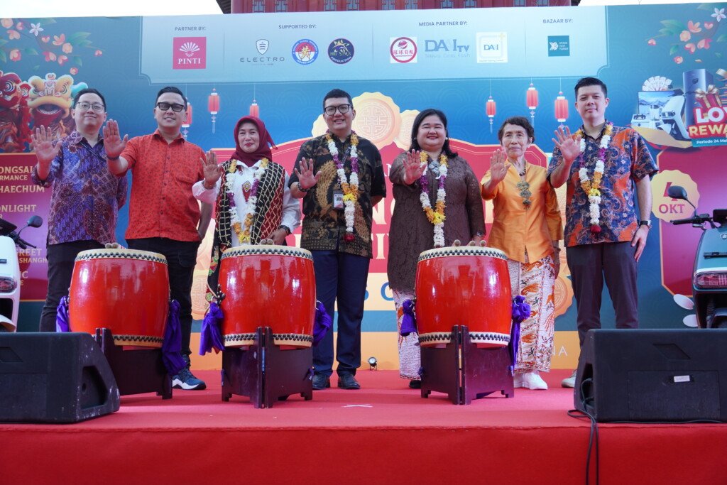 Tujuh tokoh, termasuk Kepala Dinas P3AP2 DKI Jakarta dan Ketua PINTI dr. Meta Agustina, berpose di atas panggung di samping dua drum besar saat acara Pembukaan Old Shanghai Sedayu City Mooncake Festival. Semua melambaikan tangan.