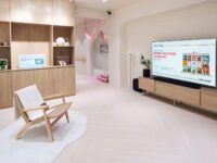 Interior ruang keluarga pada instalasi Housewarming by LG yang menampilkan konsep smart home berbasis AI dengan perangkat elektronik rumah tangga modern dan desain minimalis bergaya Korea Selatan.